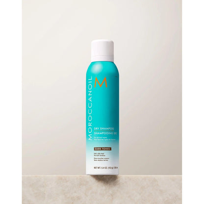 Moroccanoil Dry Shampoo for Dark Tones in a turquoise canister, designed for oil absorption and odor elimination.
