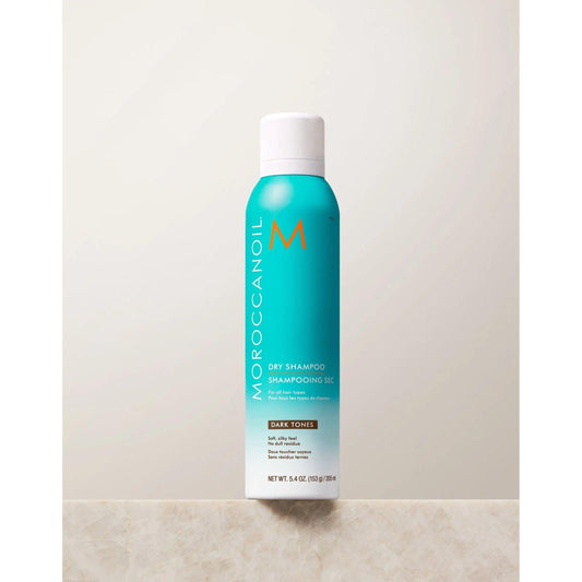 Moroccanoil Dry Shampoo for Dark Tones in a turquoise canister, designed for oil absorption and odor elimination.