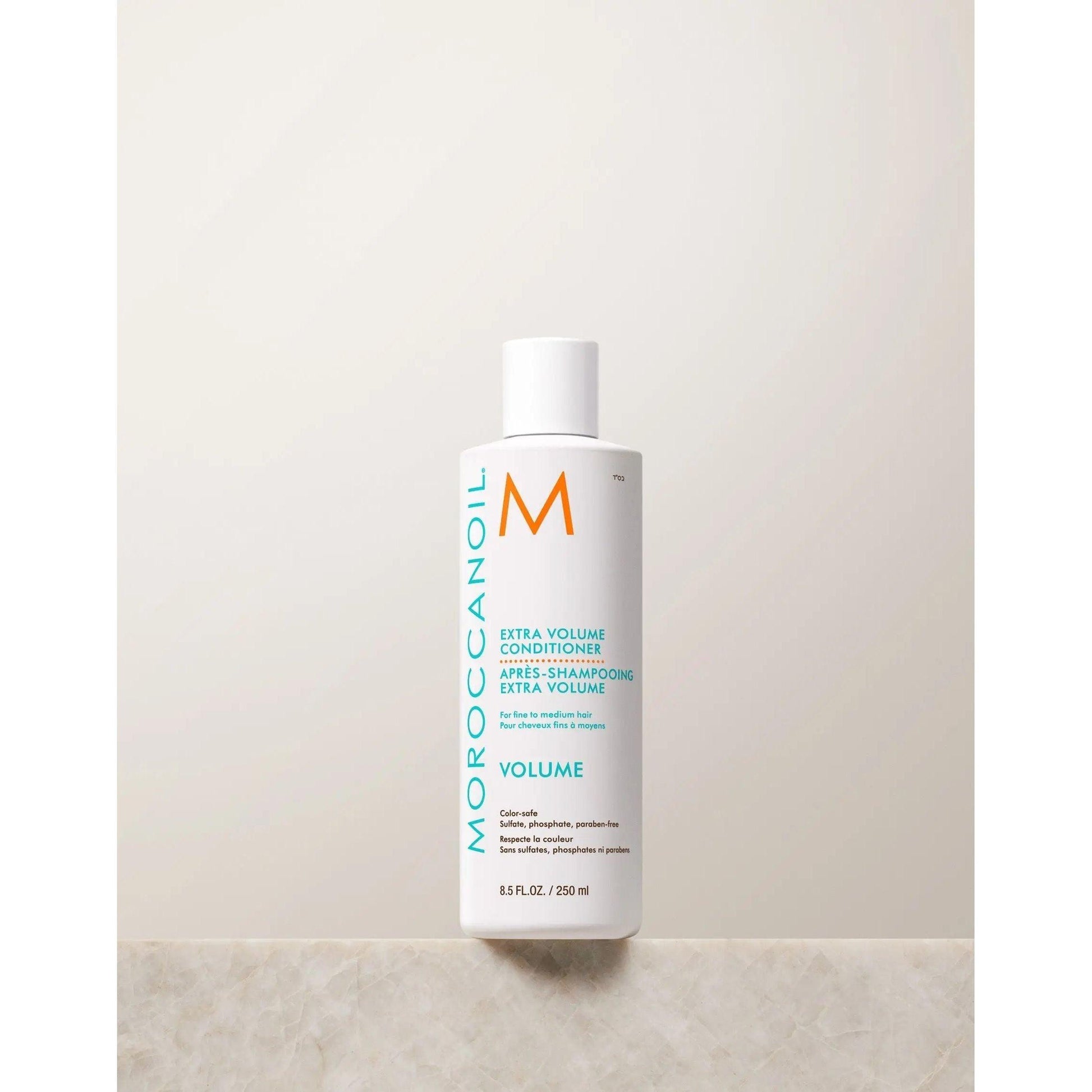 Moroccanoil Extra Volume Conditioner bottle on a neutral background, designed to add body and shine to fine hair.