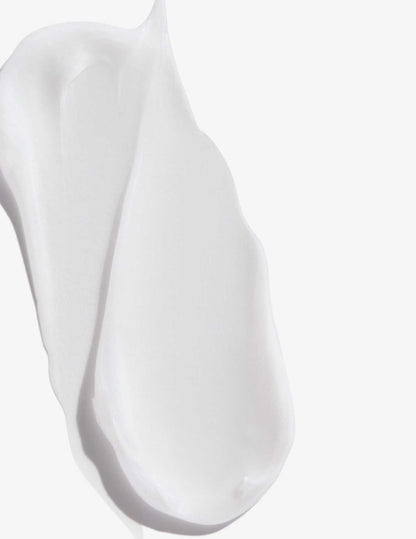 Creamy texture of Redken Extreme Length Conditioner, promoting stronger, healthier hair for all hair types.