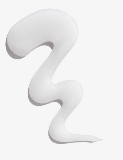 Smooth, curly swirl of white shampoo representing Redken Extreme Shampoo for damaged hair.
