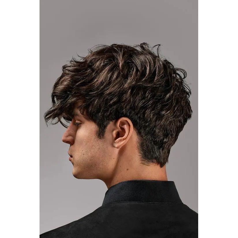 Stylish men's medium wavy haircut, side view, fashionable hairstyle trends.