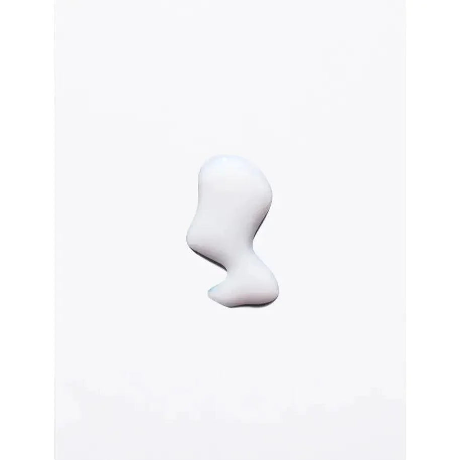 Skincare cream or lotion drop on white background, showcasing texture and consistency.