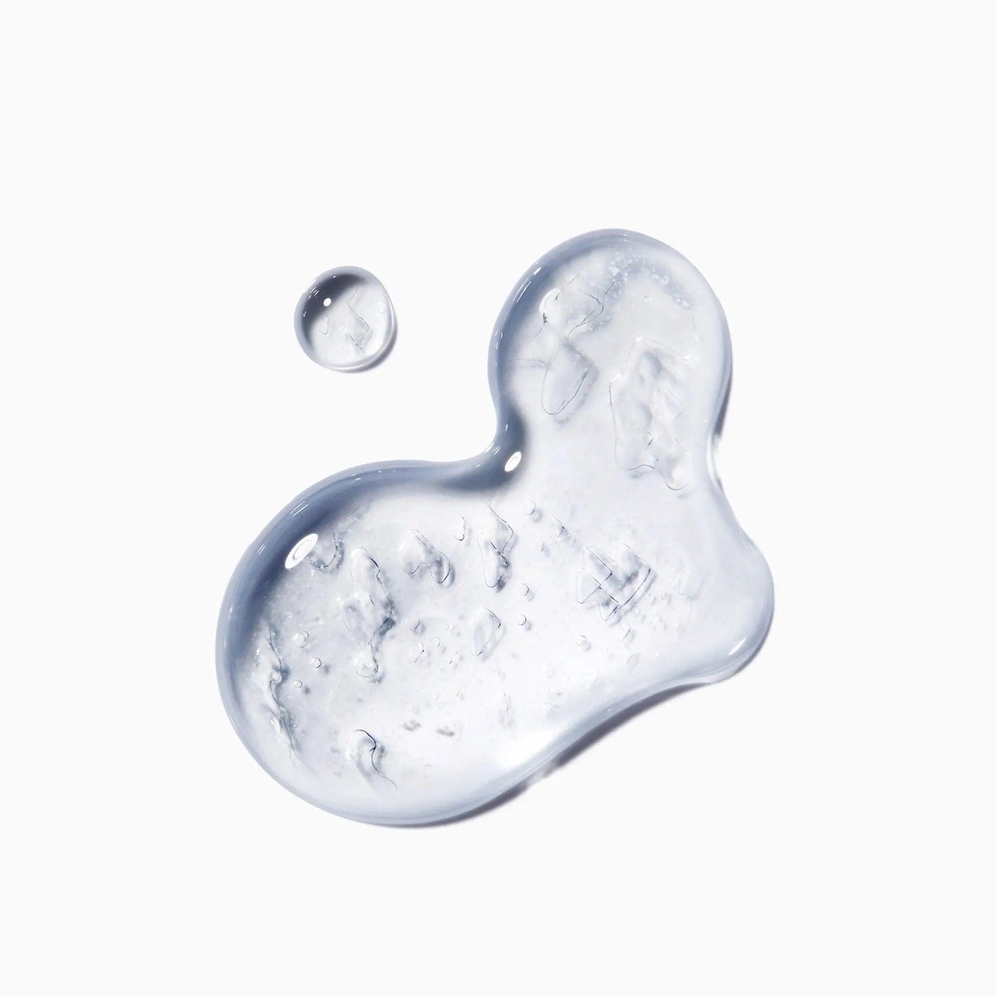 Kérastase Genesis Homme serum drop illustrating its lightweight, gel-like texture to combat hair loss.