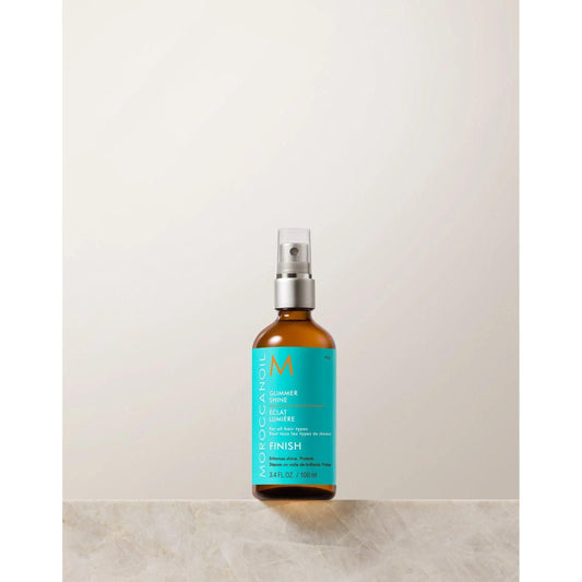 Moroccanoil Glimmer Shine Finishing Spray bottle on a neutral background, designed for radiant, shiny hair.