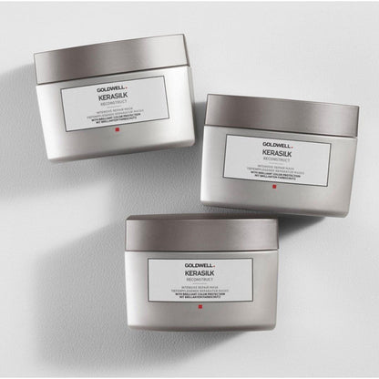 Three Goldwell Kerasilk Reconstruct Intensive Repair Mask jars arranged side by side for hair restoration and moisture.