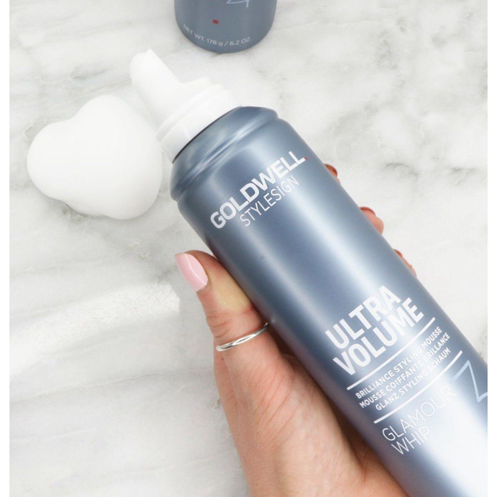 Goldwell Stylesign Ultra Volume Glamour Whip Mousse in hand, showcasing creamy styling product for radiant hair.