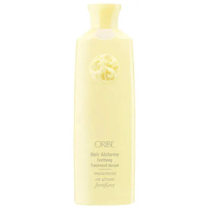 ORIBE Hair Alchemy Fortifying Treatment Serum in a sleek yellow bottle, designed to strengthen and protect hair.