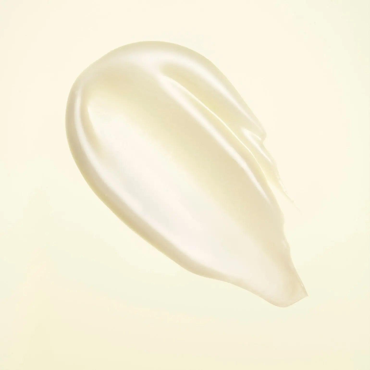 smooth and creamy texture of Hair Alchemy Resilience Conditioner against a soft background