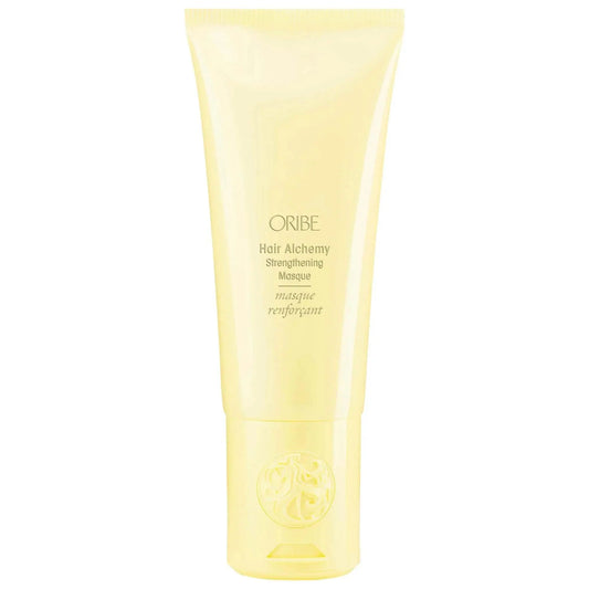 Oribe Hair Alchemy Strengthening Masque in a sleek yellow tube, designed to nourish and strengthen fragile hair.