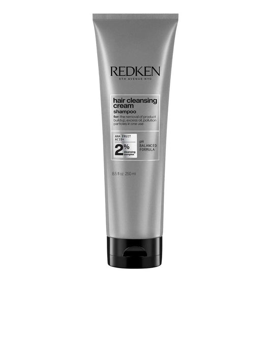 Redken Hair Cleansing Cream Shampoo in a silver tube, clarifying formula for all hair types and textures, promoting freshness.