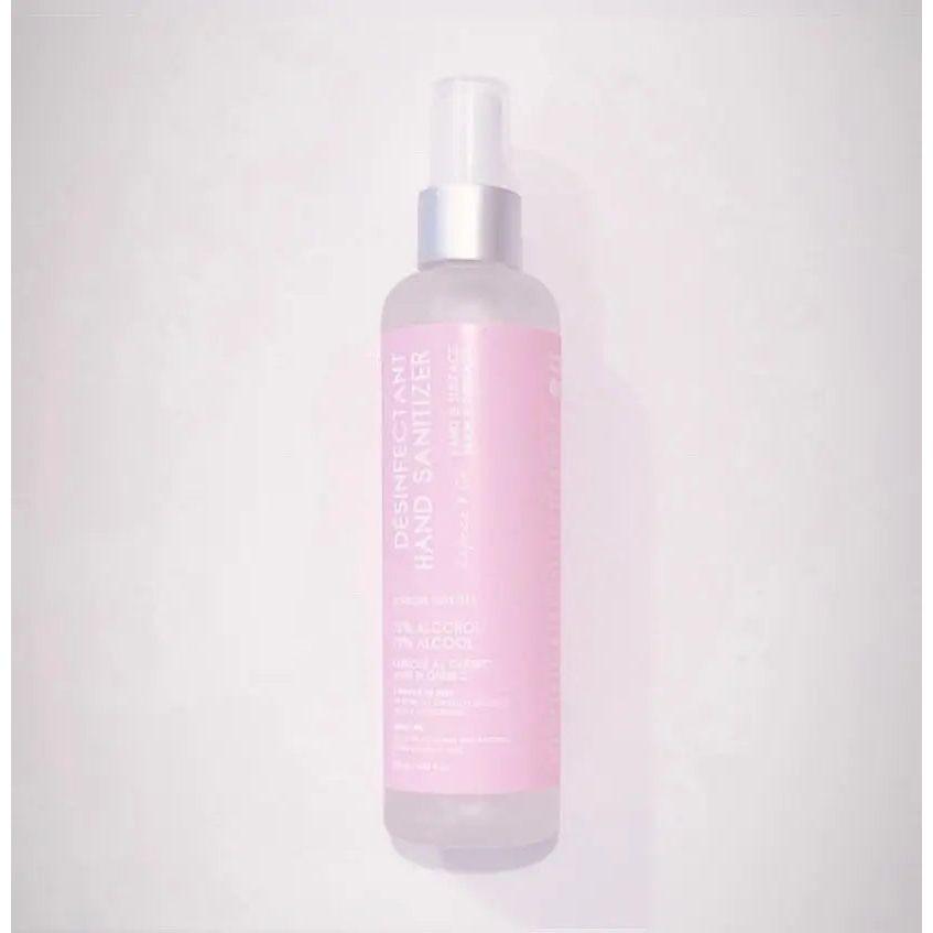 Hand sanitizer spray in a pink bottle, 3.38 fl oz, scented with sour candy, certified by Health Canada for effective germ removal.