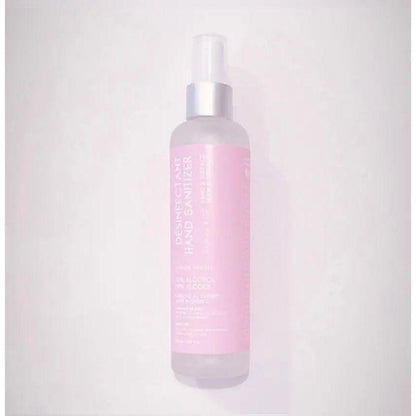 Hand sanitizer spray in a pink bottle, 3.38 fl oz, scented with sour candy, certified by Health Canada for effective germ removal.