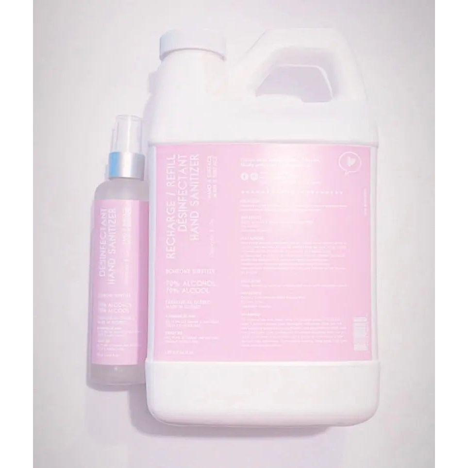Hand sanitizer refill kit with spray bottle and larger container, featuring pink labels and instructions for use.