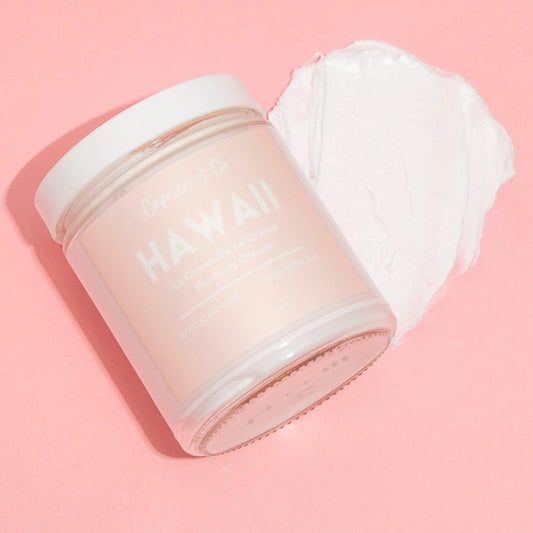 Hawaii body cream in a glass jar with creamy texture on pink background, hydrating with natural ingredients.