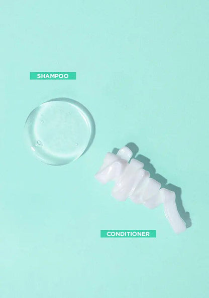 Hydrating shampoo and conditioner display on a mint green background, showcasing their textures for great hair days.