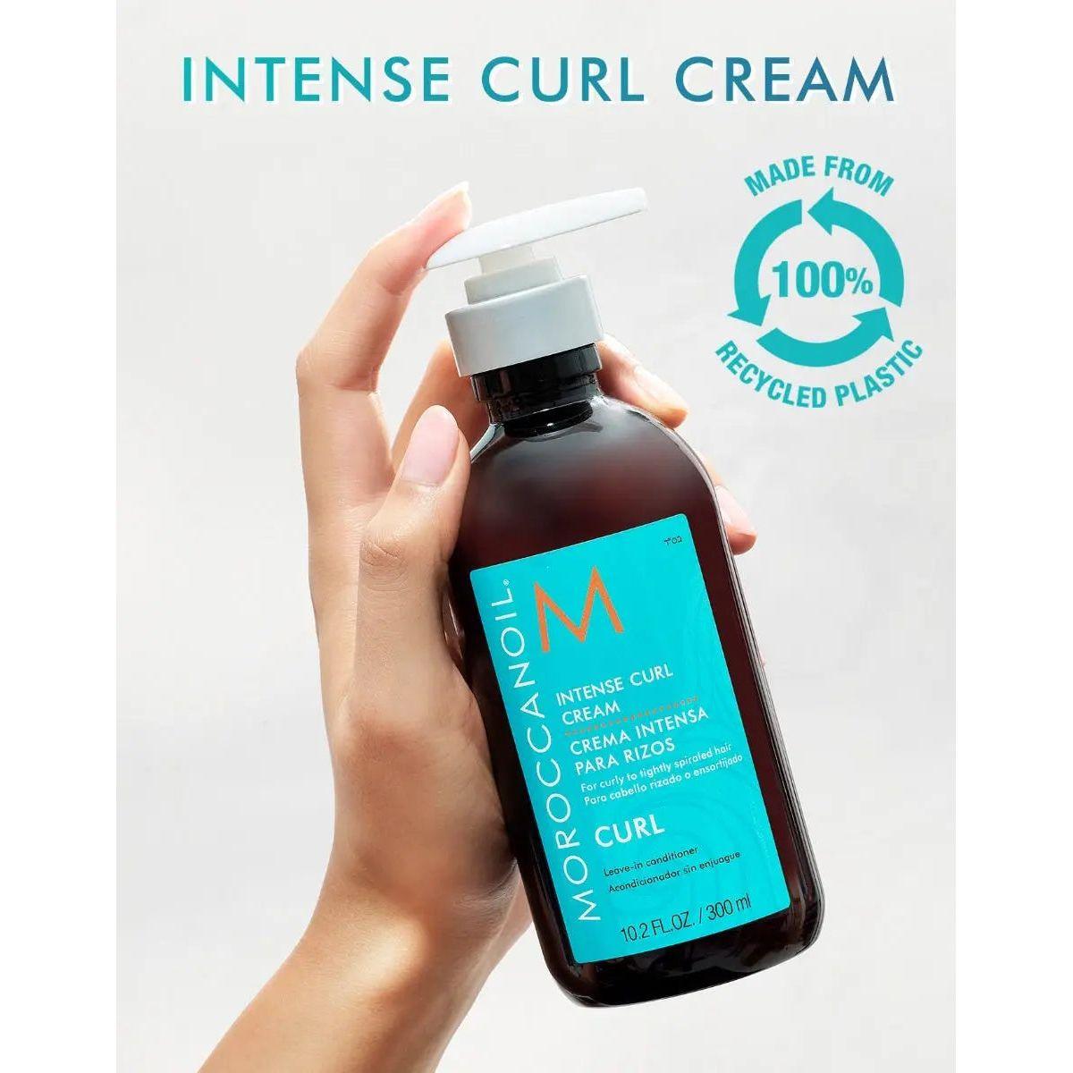 Moroccanoil Intense Curl Cream bottle in hand, showcasing eco-friendly packaging made from 100% recycled plastic.