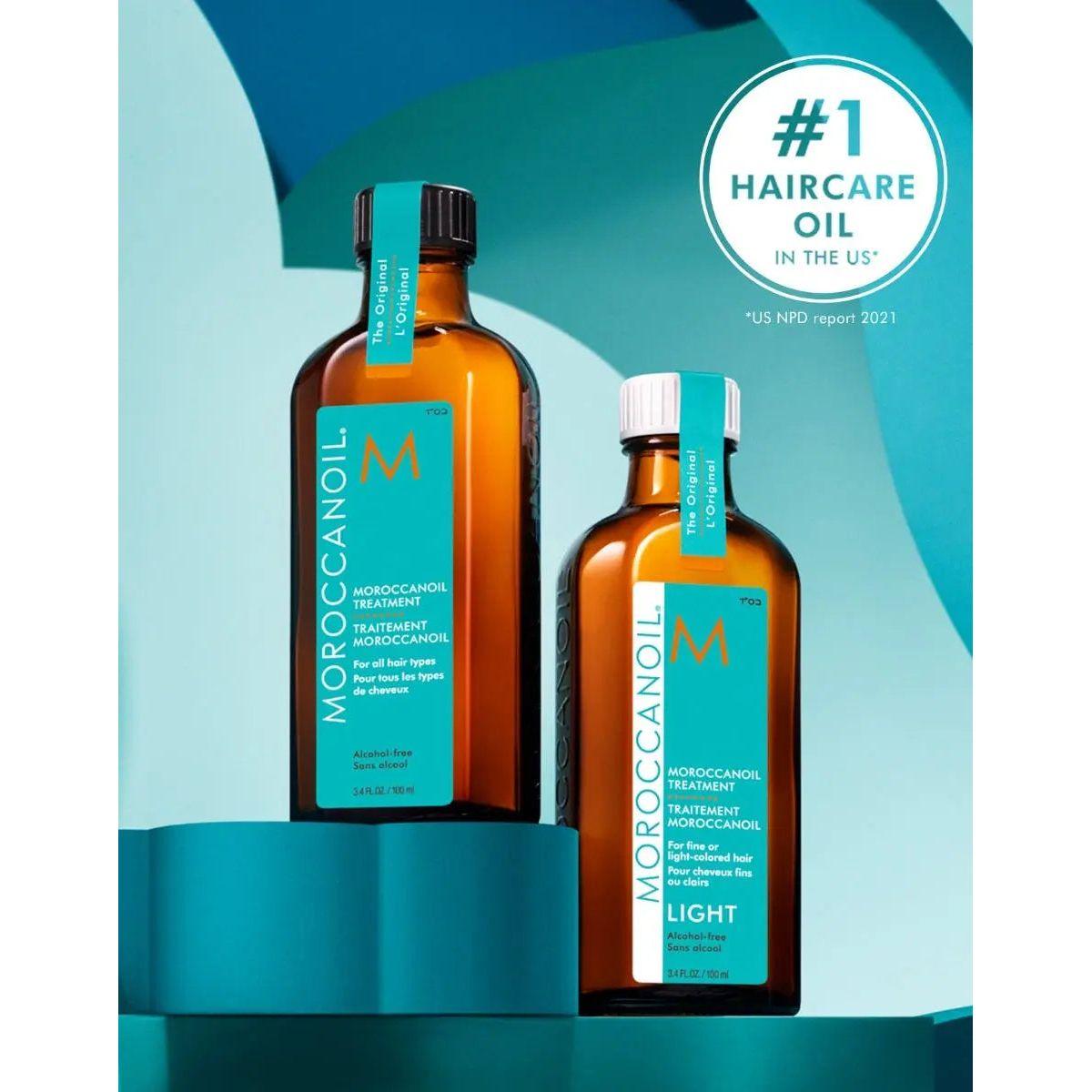Moroccanoil Light Treatment and Original Treatment bottles on a modern display, showcasing #1 haircare oil in the US.