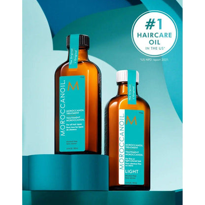 Moroccanoil Light Treatment and Original Treatment bottles on a modern display, showcasing #1 haircare oil in the US.