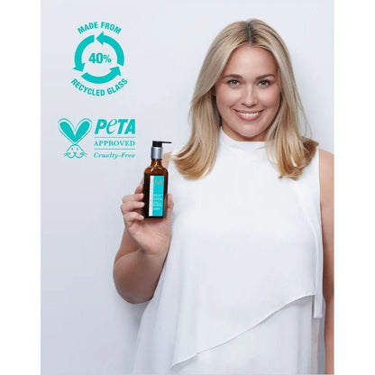 Model showcasing a lightweight argan oil hair treatment in a 40% recycled glass bottle, cruelty-free and PETA approved.
