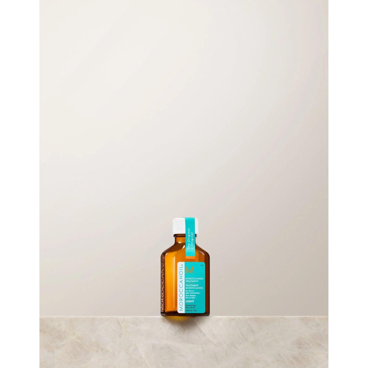 Moroccanoil lightweight argan oil hair treatment for fine hair, promoting shine, softness, and frizz control.