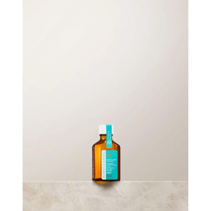 Moroccanoil lightweight argan oil hair treatment for fine hair, promoting shine, softness, and frizz control.