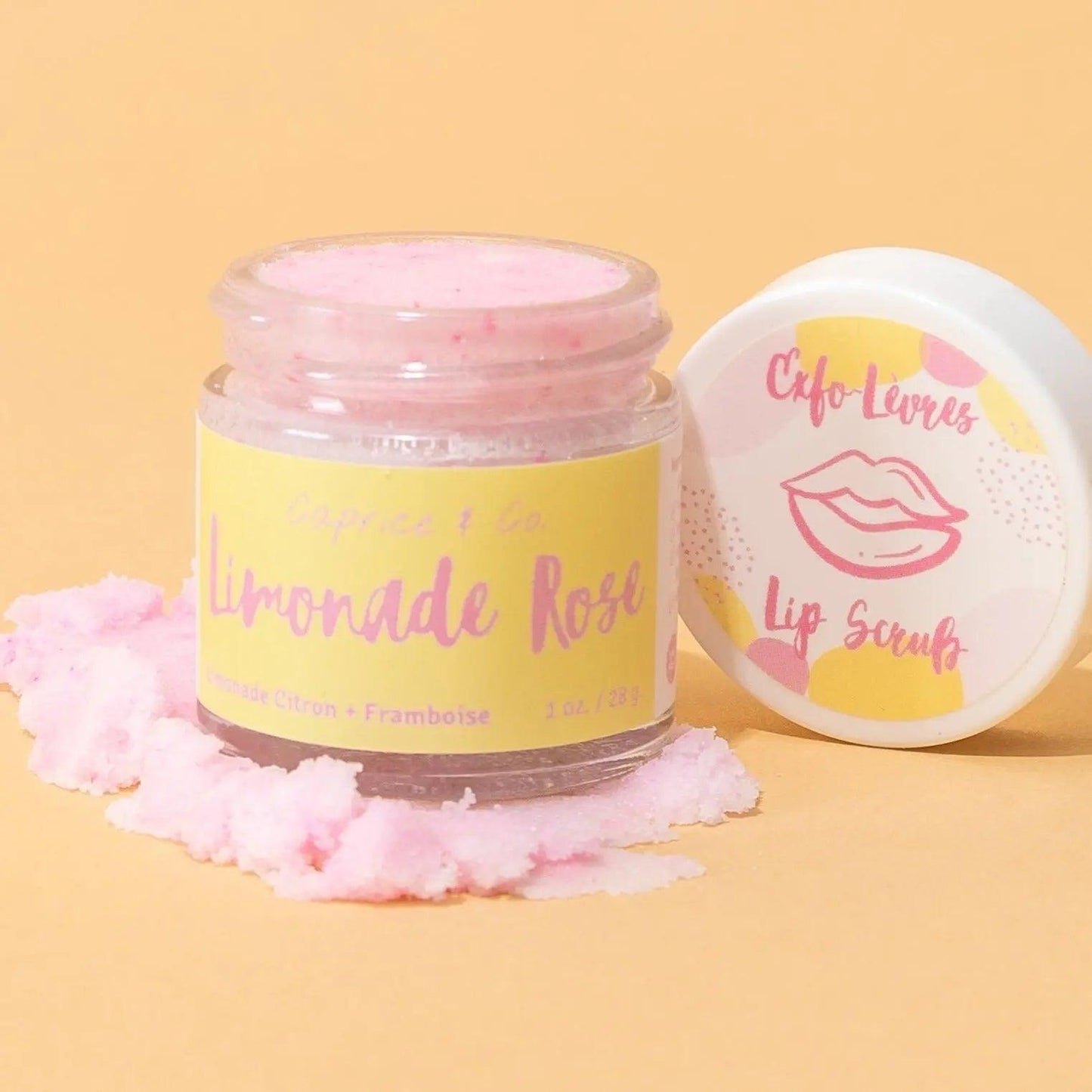 Limonade Rose lip scrub in a jar with pink sugar on a yellow background, perfect for gentle lip exfoliation and hydration.
