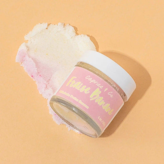 Strawberry banana lip scrub jar with exfoliating sugar scrub on a peach background. Perfect for smooth, soft lips.