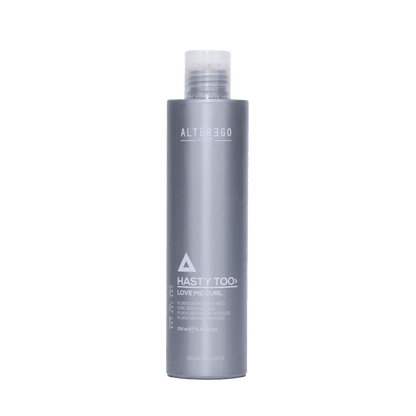Hasty Too Love Me Curl modeling fluid for natural curl control and soft, defined curls in a sleek gray bottle.