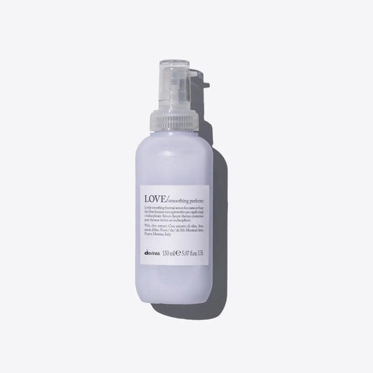 Love Smoothing Perfector thermal serum for frizzy hair in sleek spray bottle, offering thermal protection and easy styling.