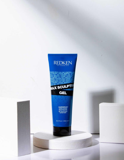 Redken Max Sculpting Gel in a blue tube on display, designed for maximum hold and control for all hair types.