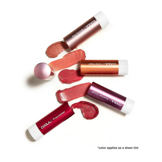 Coola Mineral Liplux tinted lip balms with swatches in shades, showcasing SPF 30 protection and organic ingredients.