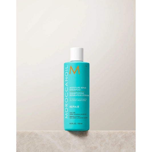 Moroccanoil Moisture Repair Shampoo bottle on a neutral background, designed to cleanse and repair damaged hair.