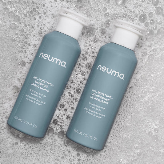 NEU Moisture Duo Shampoo and Conditioner bottles on a bubbly surface, perfect for daily hydration and hair health.