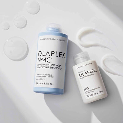 Olaplex No. 4C Bond Maintenance Clarifying Shampoo and No. 3 Hair Perfector bottles with shampoo textures. Ideal for all hair types.