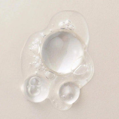 Clear, lightweight hair serum drops showcasing nourishing bubbles for hair protection and shine.