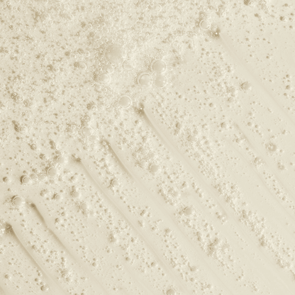 Creamy body wash with bubbles, illustrating a gentle and nourishing formula for sunless tanning aftercare.