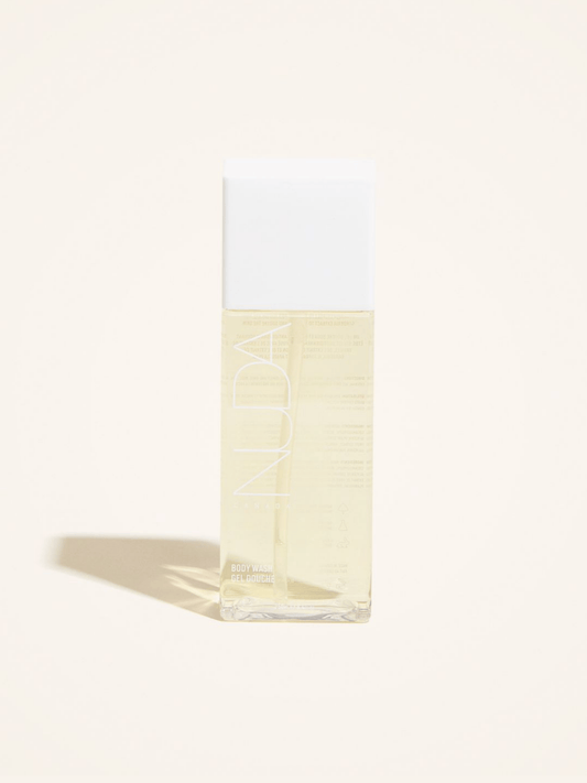 Nuda Body Wash in clear bottle, designed for sunless tanning aftercare with antioxidants and lemon extract.