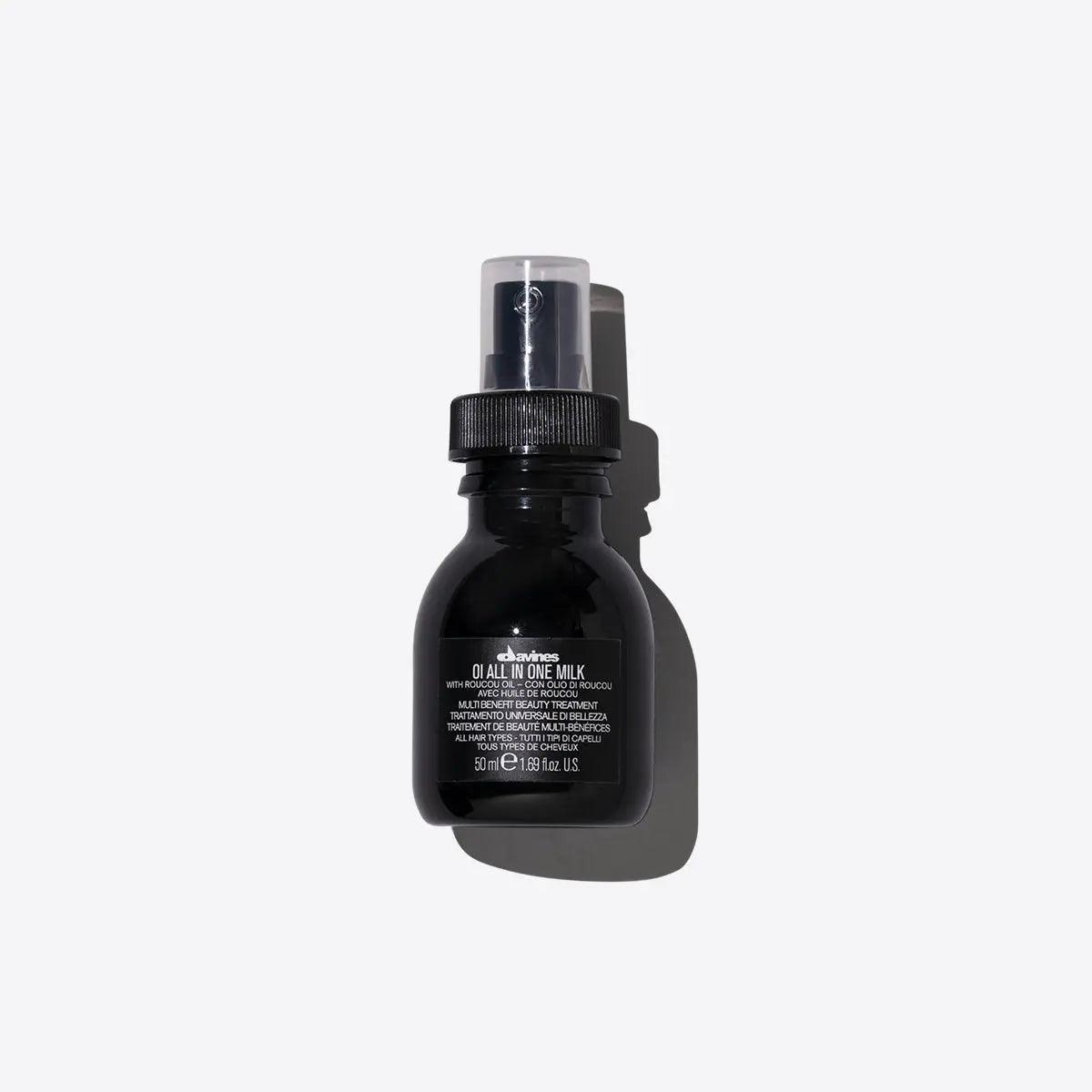 Black hair care product bottle against white background