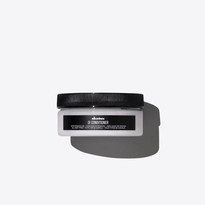 High-quality Davines OI Conditioner for all hair types in sleek packaging on gray background