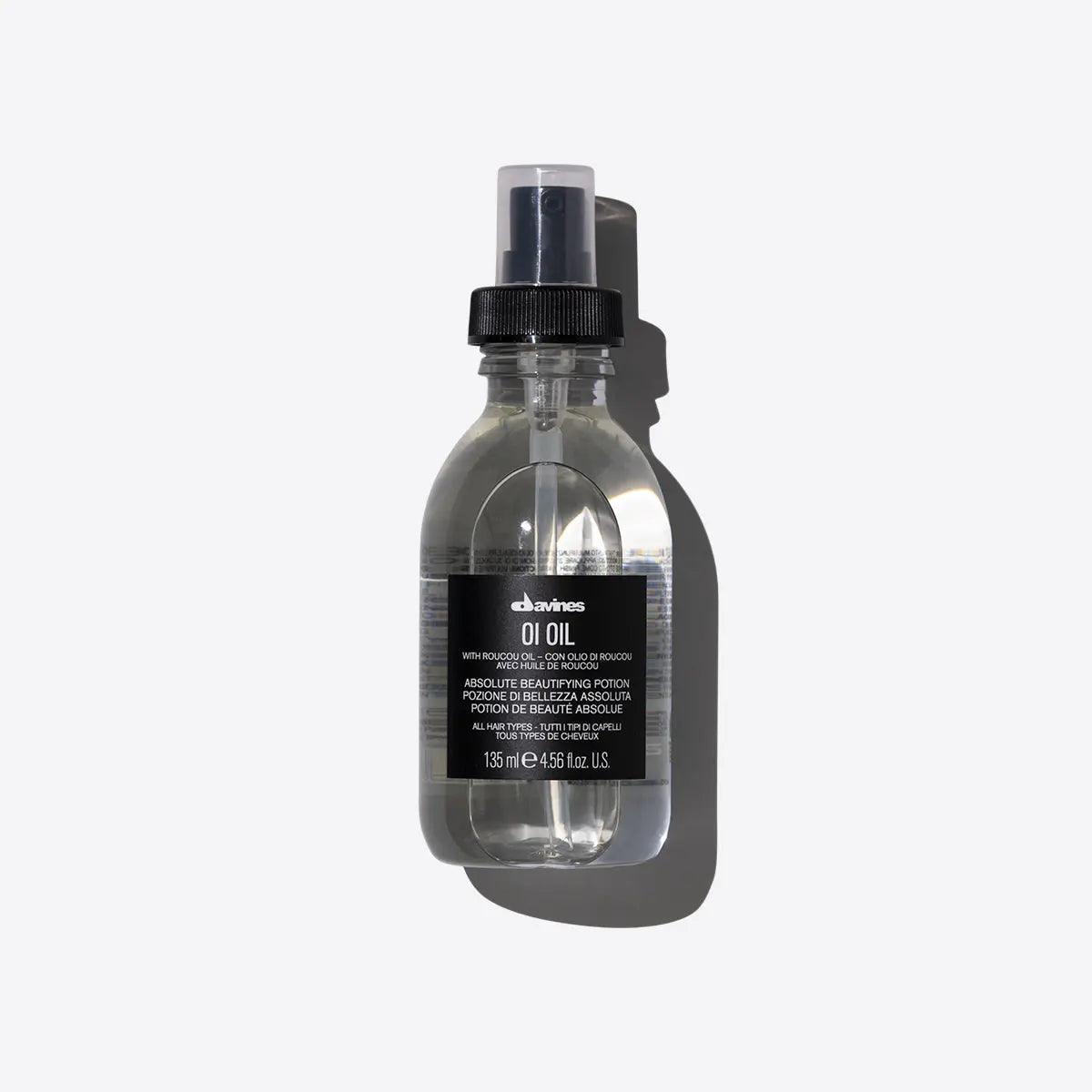 "Davines OI Oil, 135ml bottle, hair beautifying potion, with roucou oil, transparent liquid, black spray cap, product shot on white background"
