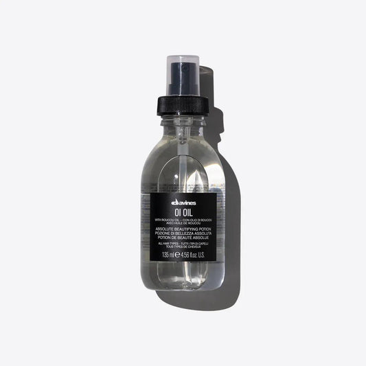 "Davines OI Oil, 135ml bottle, hair beautifying potion, with roucou oil, transparent liquid, black spray cap, product shot on white background"