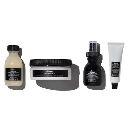 Davines Oi Travel Gift Set featuring Oi Shampoo, Oi Conditioner, Oi All-In-One Milk, and Oi Hand Balm for hair and skin care.