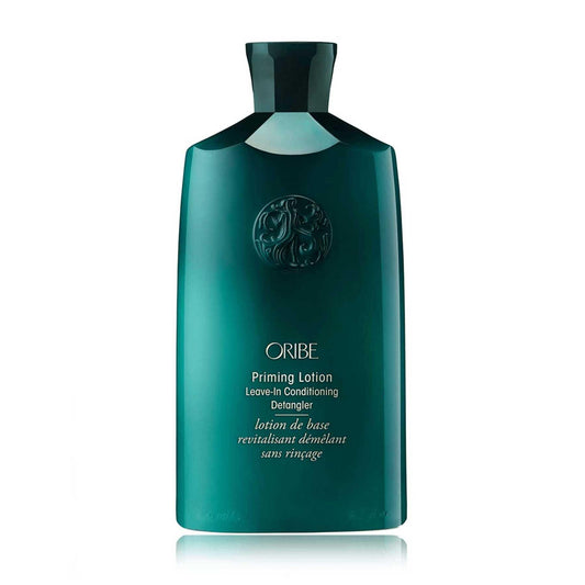 Oribe Priming Lotion Leave-In Conditioning Detangler in a sleek green bottle, designed for detangling and hydrating curls.