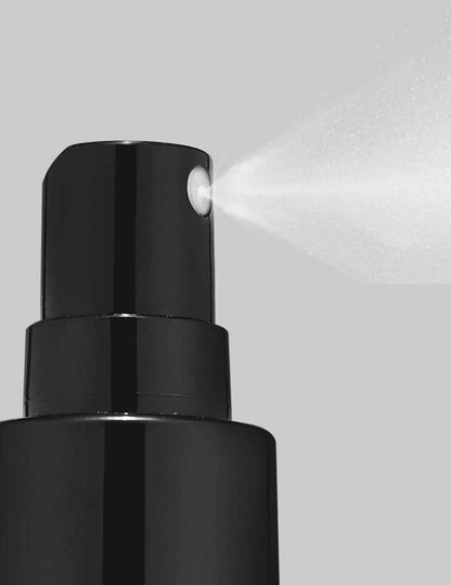 Redken Quick Blowout spray nozzle dispensing a lightweight blow-dry spray for faster styling and heat protection.