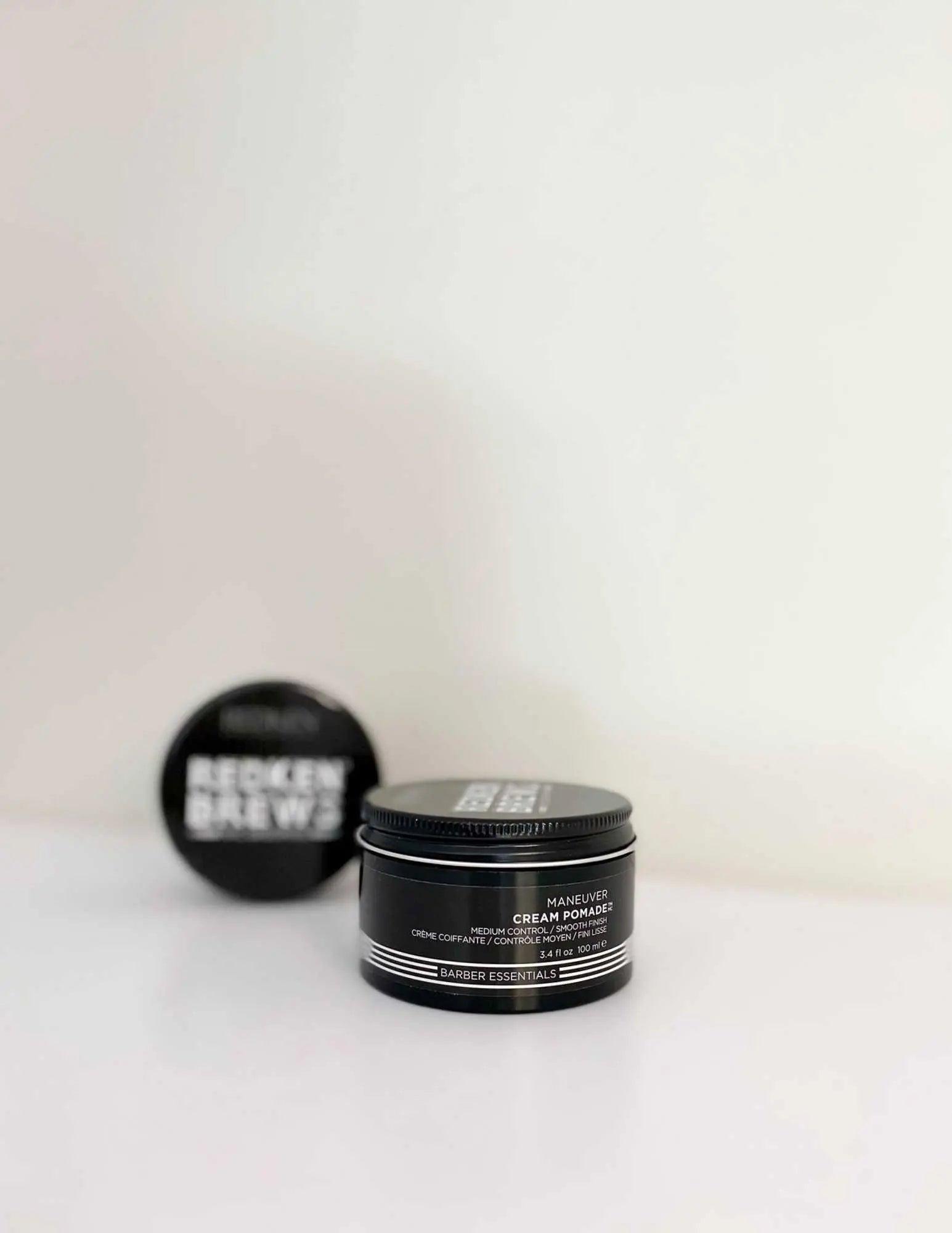 Redken Brews Maneuver Cream Pomade jar on a white background, showcasing versatile hair styling for men.
