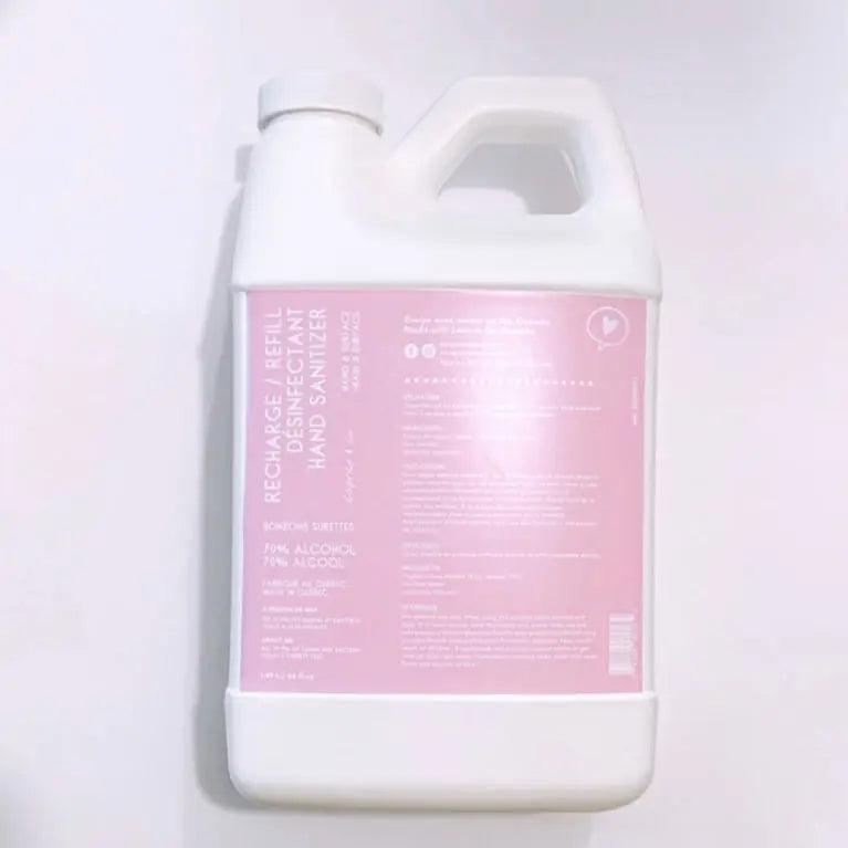 Refill hand sanitizer spray bottle, 66.5 fl oz, with pink label and instructions, effective against germs and bacteria.
