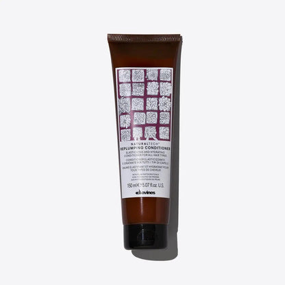 Replumping Conditioner tube by Davines, packed with moisturizing ingredients for elastic and untangled hair.