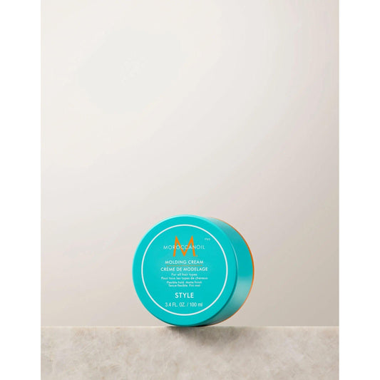 Molding Cream by Moroccanoil in a turquoise container, a fiber-rich texturizing cream for versatile styling.