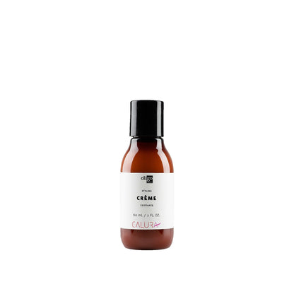 2 oz bottle of Calura Styling Crème for flexible hold and shine, suitable for all hair types, vegan and sulfate free.
